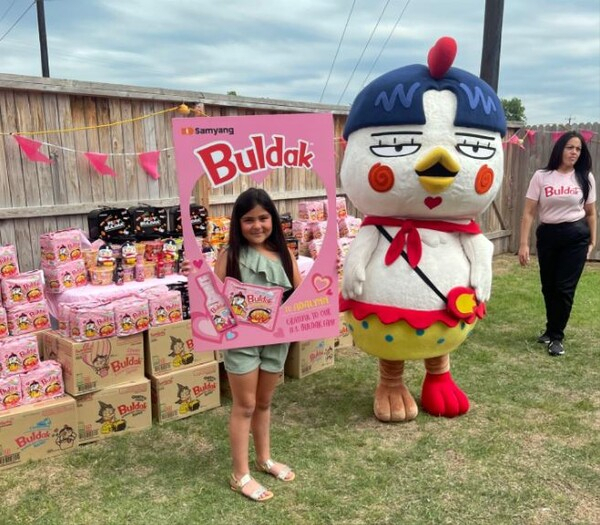 Adalynn Sofia poses for a photo in her backyard, which has been decorated in a Buldak Carbonara Ramen theme, in Texas. (Samyang Roundsquare)