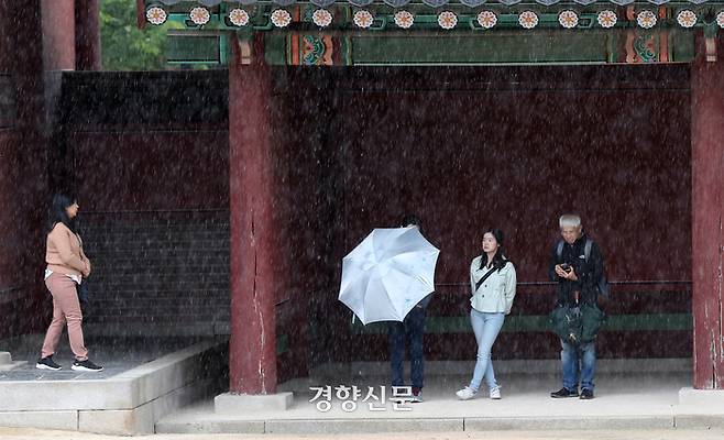 부처님오신날인 15일 서울 종로구 창덕궁을 찾은 외국인 관광객들이 처마밑에서 비를 피하고 있다. 정지윤 선임기자