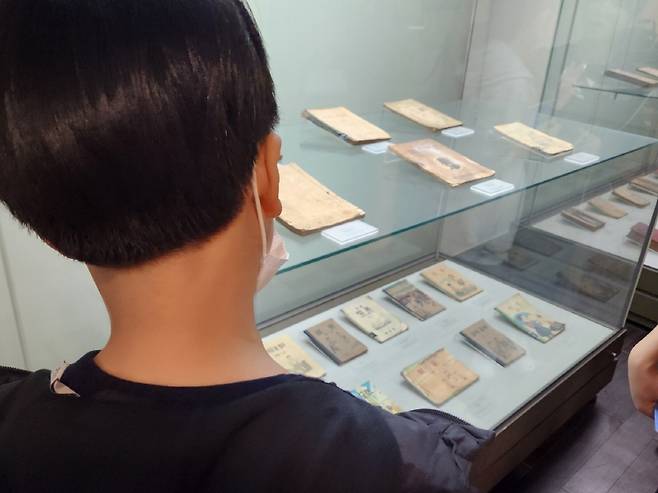 학생들이 삼성출판박물관에 전시되어 있는 옛 교과서를 유심히 살펴보고 있다.