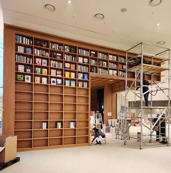 수원 별마당도서관 책장 윗부분에 모형 책을 설치하는 모습. /우진메이킹
