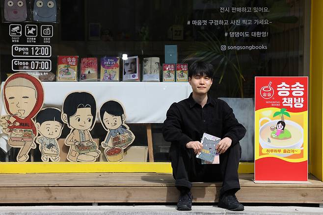 2024년 4월29일 서울 종로구 송송책방에서 잇선 작가가 작품 <이상징후>를 들고 포즈를 취하고 있다. 류우종 기자