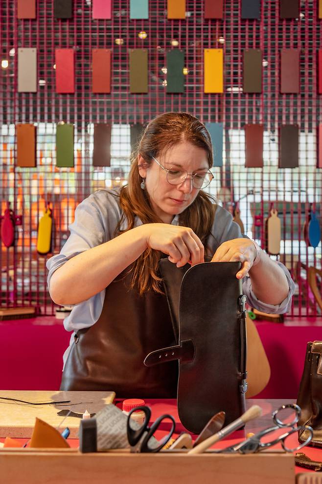 An Hermes artisan from France works on a leather bag. (Hermes Korea Limited)