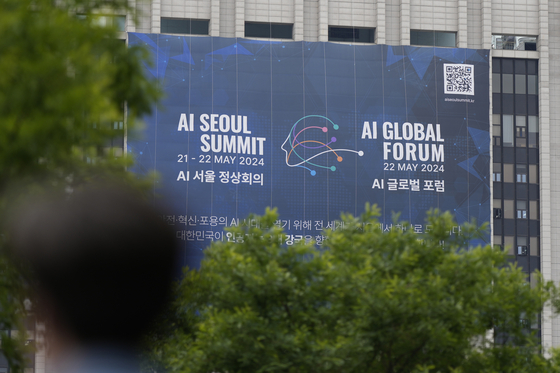 A banner is seen for the upcoming AI Seoul Summit and AI Global Forum in Seoul Monday. Korea and Britain are set to host the summit on Tuesday on risks and regulation of artificial intelligence, following up on the inaugural meeting held in England last November. [AP/YONHAP]