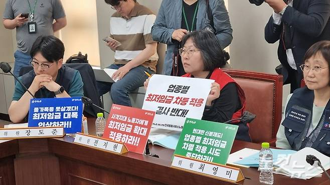 5월 21일 정부세종청사에서 열린 최저임금위원회 제1차 전원회의에서 근로자위원으로 참석한 전지현 전국돌봄서비스노조 위원장이 '업종별 최저임금 차등적용 결사반대'가 씌어진 종이를 들고 있다. 김민재 기자
