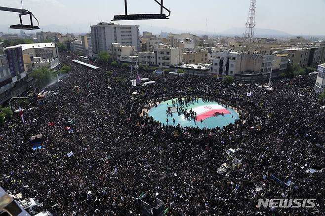 [테헤란=AP/뉴시스] 22일(현지시각) 이란 수도 테헤란에서 고 에브라힘 라이시 대통령과 헬기 추락 사고 희생자들의 장례식이 열려 수많은 이란 사람이 참석하고 있다. 고인들을 추모하는 수만 인파가 테헤란을 통과하는 운구행렬을 따른 것으로 알려졌다. 2024.05.22.
