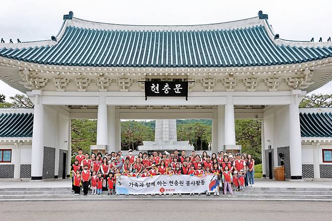 롯데건설 ‘샤롯데 봉사단’이 봉사활동 후 현충문 앞에서 기념촬영을 하고 있다. [롯데건설 제공]