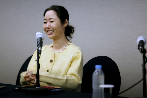 ADOR CEO Min Hee-jin smiles during Friday's press conference. [JOINT PRESS CORPS]