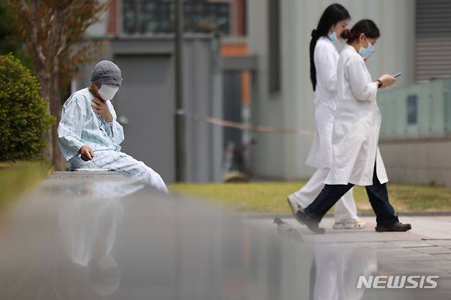 [서울=뉴시스] 김명년 기자 = 지난 7일 오후 서울 종로구 서울대학교병원에서 한 환자가 야외의자에  앉아 있는 모습. 2024.06.07. kmn@newsis.com