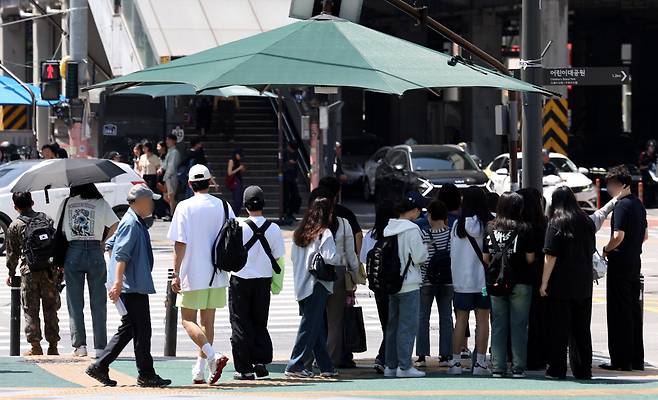 햇볕을 피 그늘막 아래 모여있는 시민들 /사진=뉴시스