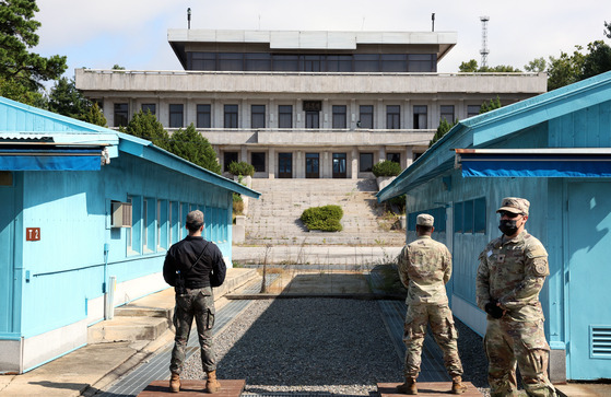 Two South Korean soldiers face the North Korean side of the Joint Security Area (JSA) while a United Nations Command officer, right, leads a tour of the truce village of Panmunjom in Paju, South Korea on March 3, 2023. [JOINT PRESS CORPS]