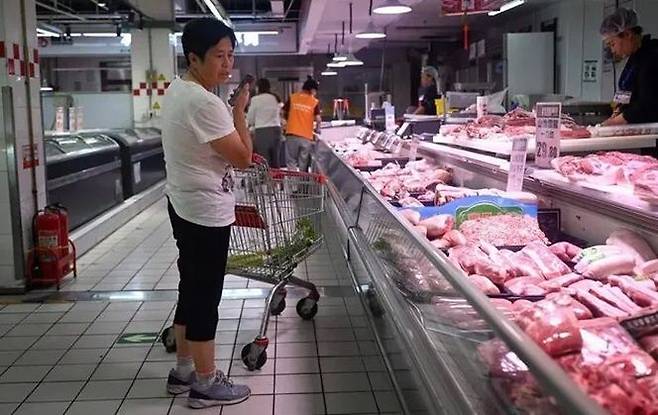 중국 베이징의 한 마트에서 한 여성이 돼지고기를 고르고 있다. ⓒ AFP/연합뉴스