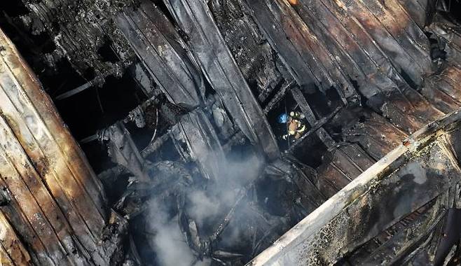 A firefighter is searching for missing people at the site of a fire at a lithium battery plant in Sinseo-myeon, Hwaseong, Gyeonggi Province on June 24. Cho Tae-hyung