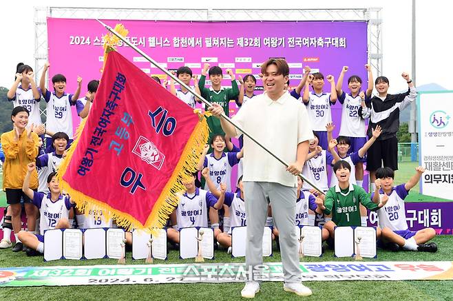 전남 광양여고 권영인 감독이 27일 경남 합천군 군민체육공원에서 진행된 ‘2024 스포츠 명품도시 웰니스 합천에서 펼쳐지는 제32회 여왕기 전국여자축구대회’ 고등부 울산 현대고와 결승전에서 승리하며 우승을 차지한 뒤 우승기를 흔들어 보이며 기념촬영을 하고 있다. 2024. 6. 27.  합천 | 박진업 기자 upandup@sportsseoul.com