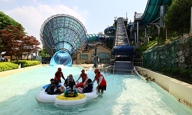 인기 어트랙션인 메가스톰 이용객들이 수상안전요원들의 도움을 받으며 안전지대로 이동하고 있다.