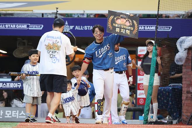 드림 올스타 류지혁이 6일 인천SSG랜더스필드에서 열린 2024 KBO 올스타전에서 2회말 자녀들과 함께 타석으로 이동하고 있다. ‘저출산 대책위원장’ 팻말을 들고 나왔다. 사진 | 문학=연합뉴스