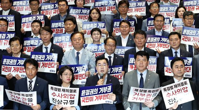 박찬대(앞줄 가운데) 더불어민주당 대표 직무대행 겸 원내대표를 비롯한 야당 의원들이 9일 오후 서울 여의도 국회 로텐더홀에서 윤석열 대통령의 순직 해병대원 특검법 거부권 행사를 규탄하고 있다. 뉴스1