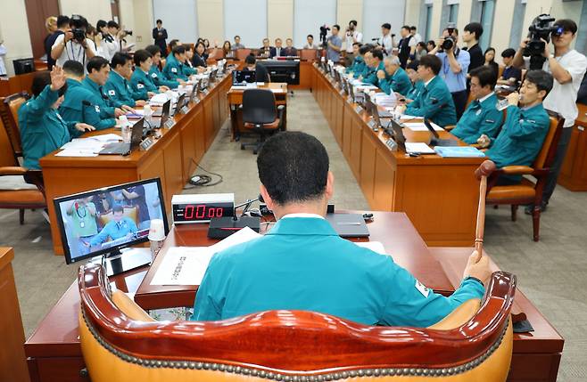 18일 국회에서 열린 행정안전위원회 전체회의에서 국민의힘 의원들이 의사진행 발언을 요청하는 가운데 더불어민주당 소속 신정훈 위원장이 의사봉을 두드리고 있다. [연합]