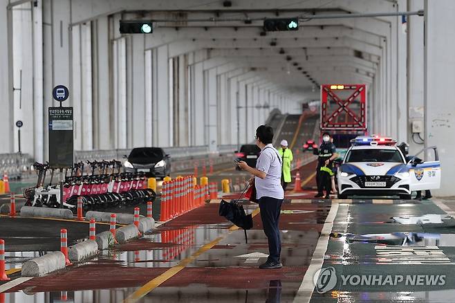 서울 잠수교 인도 통제·차량 통행은 가능 (서울=연합뉴스) 신현우 기자 = 간밤 수도권에 집중호우가 쏟아진 가운데 18일 오전 서울 잠수교 남단에서 경찰이 보행자 통행을 통제하고 있다.
    잠수교는 수위가 5.50ｍ를 넘을 경우 보행자, 6.20ｍ를 넘을 경우 차량 통행이 중단된다. 경찰 관계자는 "현재 수위가 5.50ｍ를 넘지는 않았으나 선제적으로 조치했다"고 밝혔다. 2024.7.18 nowwego@yna.co.kr