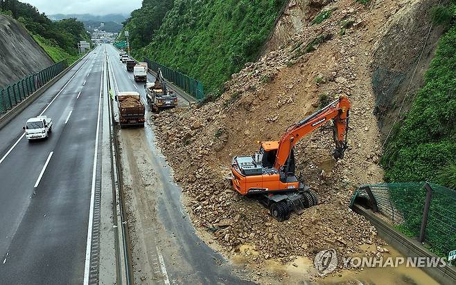 토사 흘러내려 통제되는 고속도로 (용인=연합뉴스) 지난 18일 경기도 용인시 처인구 포곡읍 수도권제2순환고속도로 봉담 방면 금어2교 부근 2차로 도로 옆 경사면 토사가 흘러내리며 도로가 통제돼 관계자들이 복구작업을 하고 있다. 2024.7.18 [중부일보 제공. 재판매 및 DB 금지]