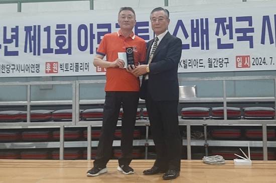 제1회 아르크투루스배 전국시니어당구대회 에서 준우승한 강명준이 대한당구시니어연맹  양춘수 회장과 포즈를 취하고 있다. (사진=대한당구시니어연맹)