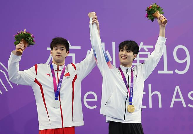 <yonhap photo-4774=""> 황선우 팔 들어 올리는 판잔러 (항저우=연합뉴스) 이지은 기자 = 27일 중국 항저우 올림픽 스포츠센터 수영장에서 열린 2022 항저우 아시안게임 수영 남자 자유형 200m 결승에서 은메달을 획득한 중국 판잔러(왼쪽)가 금메달을 획득한 황선우의 팔을 들어 올려주고 있다. 2023.9.27 jieunlee@yna.co.kr/2023-09-27 21:54:52/ <저작권자 ⓒ 1980-2023 ㈜연합뉴스. 무단 전재 재배포 금지.></yonhap>