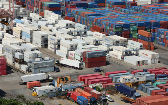 Shipping containers are stacked at Busan Port in August. [YONHAP]