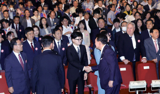 윤석열 대통령이 15일 서울 종로구 세종문화회관에서 열린 제79주년 광복절 경축식에서 퇴장하며 국민의힘 한동훈 대표와 악수하고 있다. 연합뉴스