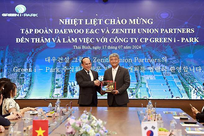 대우건설 정원주 회장(사진 오른쪽)이 지난 7월 17일 현지업체인 그린아이파크 응우옌 밍 흥 회장을 만나 끼엔장신도시 개발을 위한 현안을 논의했다. 대우건설 제공