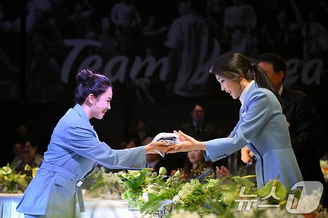 김건희 여사가 22일 서울 중구 신라호텔에서 열린 '2024 파리올림픽 선수단 격려 행사'에서 탁구 전지희 선수로 부터 파리올림픽 선수들이 사인한 티셔츠를 선물받고 있다. (대통령실 제공)2024.8.22/뉴스1 ⓒ News1 송원영 기자