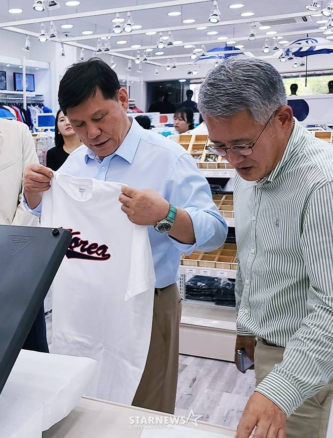 허구연(왼쪽) KBO 총재가 조준 오피스디포코리아 대표와 함께 마킹된 티셔츠와 마킹 기계를 살피고 있다. /사진=김우종 기자