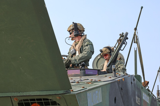 U.S. Marines conduct checks on an amphibious combat vehicle at a beach in Pohang, North Gyeongsang, on Sunday before the start of the Ssangyong joint landing exercise. [YONHAP]