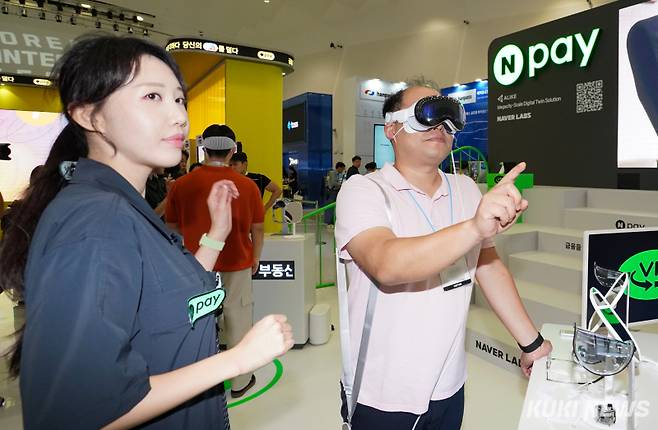 27일 서울 중구 동대문디자인플라자 아트홀에서 열린 '코리아 핀테크 위크 2024'에서 관람객이 네이버페이 부스의 '부동산 VR 투어'를 시연하고 있다.