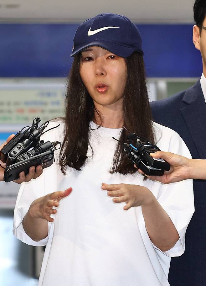 Then-Ador CEO Min Hee-jin speaks to reporters while leaving Yongsan Police Station in Seoul on July 9, following questioning over her alleged breach of trust. (Newsis)