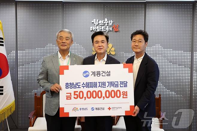 이승찬 계룡건설 회장(오른쪽)이 김태흠 지사(가운데)에게 호우 피해 복구 지정 기탁금 5000만원을 전달한 뒤 기념촬영을 하고 있다. 왼쪽은 김학수 대한적십자사 충남지사 부회장. (충남도 제공) /뉴스1