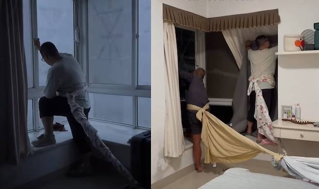 중국 가정집에서 태풍 '야기' 피해를 막기 위해 주민들이 몸을 집안에 고정시킨 채 창틀을 잡고 있다./더우인