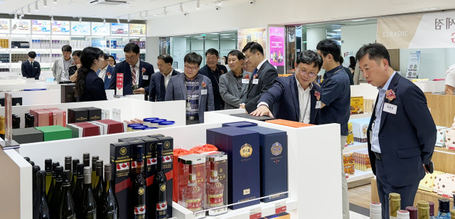 12일 청주국제공항 출국장에서 열린 경복궁면세점 개점행사에 참석한 주요 인사들이 상품을 살펴보고 있다. 사진 제공=경복궁면세점