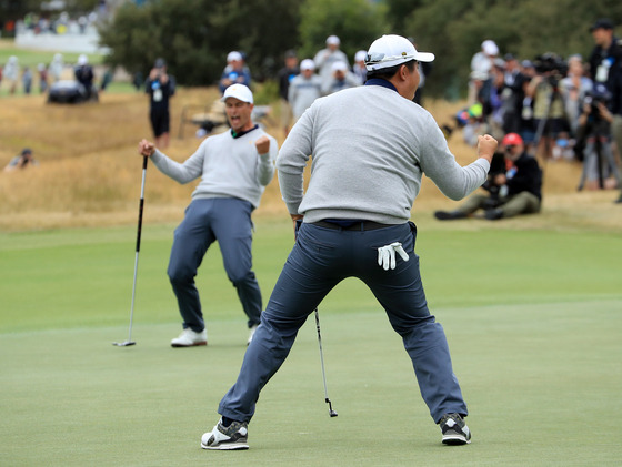 An Byeong-hun celebrates holing a birdie putt on the 17th hole in his match with Adam Scott against Tony Finau and Matt Kuchar of the United States during the afternoon four-ball matches in the 2019 Presidents Cup at Royal Melbourne Golf Club in Melbourne on Dec. 14, 2019.  [GETTY IMAGES]