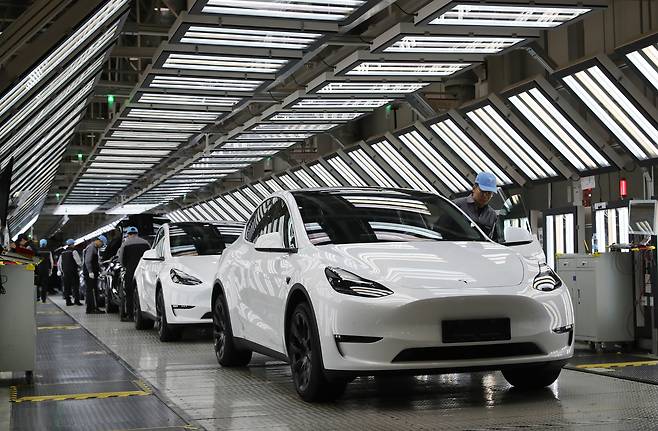 Employees work at the Tesla Gigafactory in Shanghai, China. [XINHUA/YONHAP]