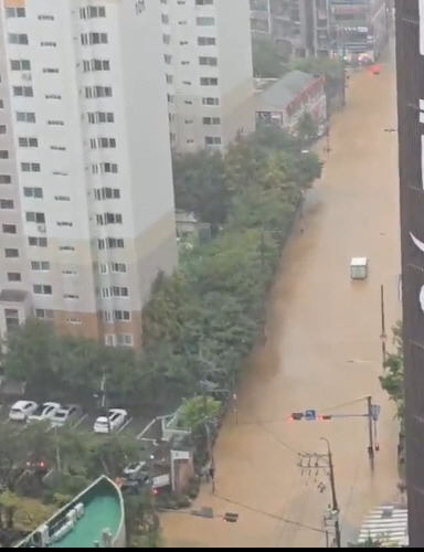 21일 오전 부산 연제구 한 도로가 폭우로 인해 물에 잠겨 있다.연합뉴스