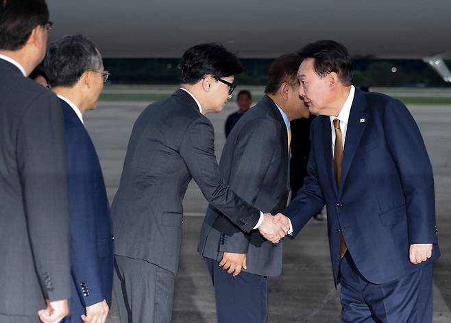 윤석열 대통령이 22일 2박4일간의 체코 순방을 마치고 경기 성남시 서울공항으로 입국하며 마중을 나온 한동훈 국민의힘 대표와 악수를 하고 있다. 두 사람은 악수를 나눈 이후 별도로 대화를 하지는 않았다.  연합뉴스