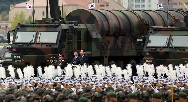 President Yoon Suk Yeol (center) passes by a transporter erector launcher carrying the Hyunmoo-5 ballistic missile during a ceremony marking Armed Forces Day on Tuesday at Seoul Air Base in Seongnam. (Yonhap)