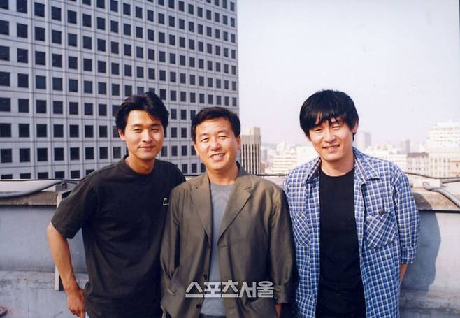 #영화 ‘공공의 적’(2002) 촬영 당시 모습. (왼쪽부터) 이성재, 강우석 감독, 설경구. 사진은 2002년 1월 10일 당시 모습. 사진 | 스포츠서울DB