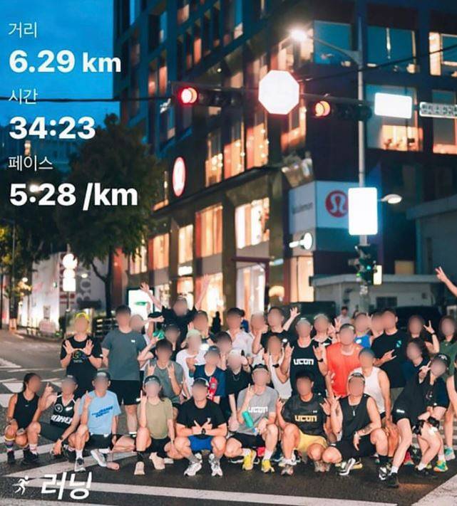 Around 30 members of a running crew pose in the middle of a crosswalk in this picture uploaded to an online community.