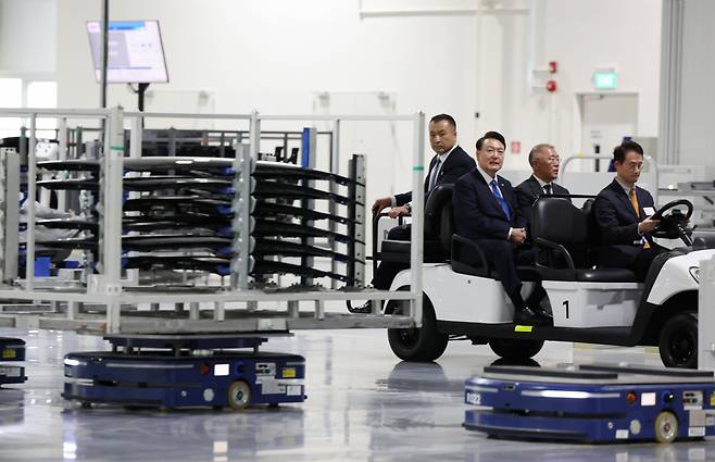 President Yoon Suk Yeol (second from left) and Hyundai Motor Executive Chair Chung Euisun (third from left) inspect the production facility at Hyundai Motor Group Innovation Center Singapore in Singapore's Jurong Innovation District on Tuesday. (Yonhap)