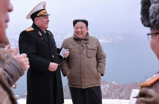 North Korean leader Kim Jong-un is seen laughing next to a naval official during a test of the Pulhwasal-3-31 cruise missile on Jan. 28 in this photo released by Pyongyang's state-controlled Korean Central News Agency. [NEWS1]