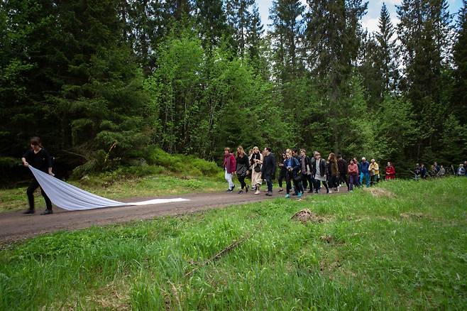 Han Kang leads a procession through Nordmarka forest during a handover ceremony in Oslo, in 2019. (Future Library)