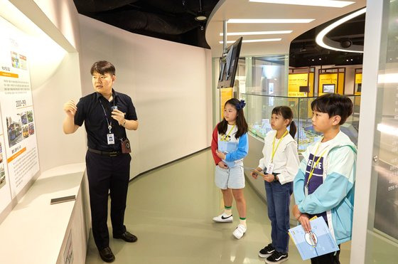 곽현준(왼쪽) 해설사에게 국토종합계획부터 대중교통의 발전 변천사까지 우리나라 국토발전에 대한 설명을 듣고 있는 소중 학생기자단.