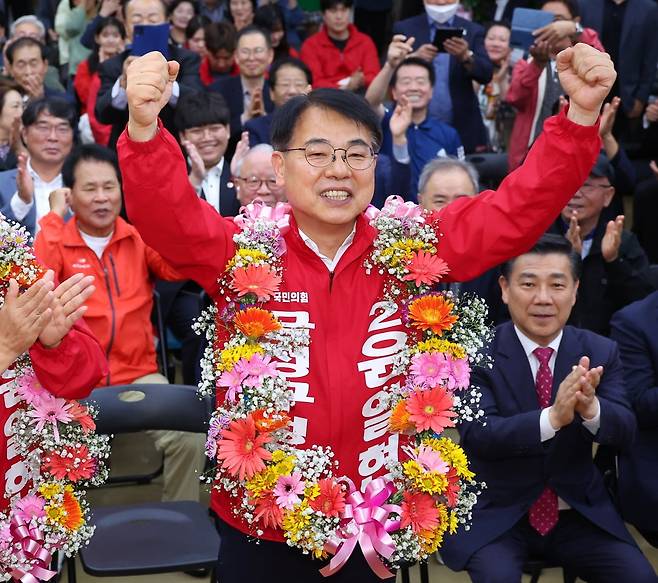 윤일현 국민의힘 금정구청장보궐선거 후보가 16일 오후 부산 금정구 선거사무소에서 당선이 유력해지자 꽃다발을 목에 걸고 환호하고 있다. / 사진=연합뉴스