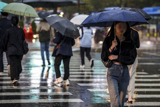 비가 내린 지난 18일 서울 종로구 광화문광장 인근에서 우산을 쓴 시민들이 이동하고 있다. 사진=뉴시스