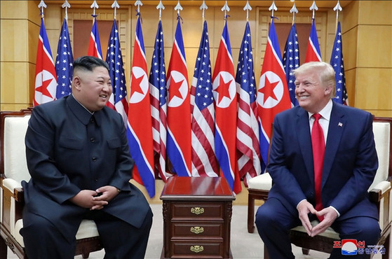 North Korean leader Kim Jong-un, left, and then U.S. President Donald Trump chat in the House of Freedom on the South Korean side of the truce village of Panmunjom on June 30, 2019. [KOREAN CENTRAL NEWS AGENCY]